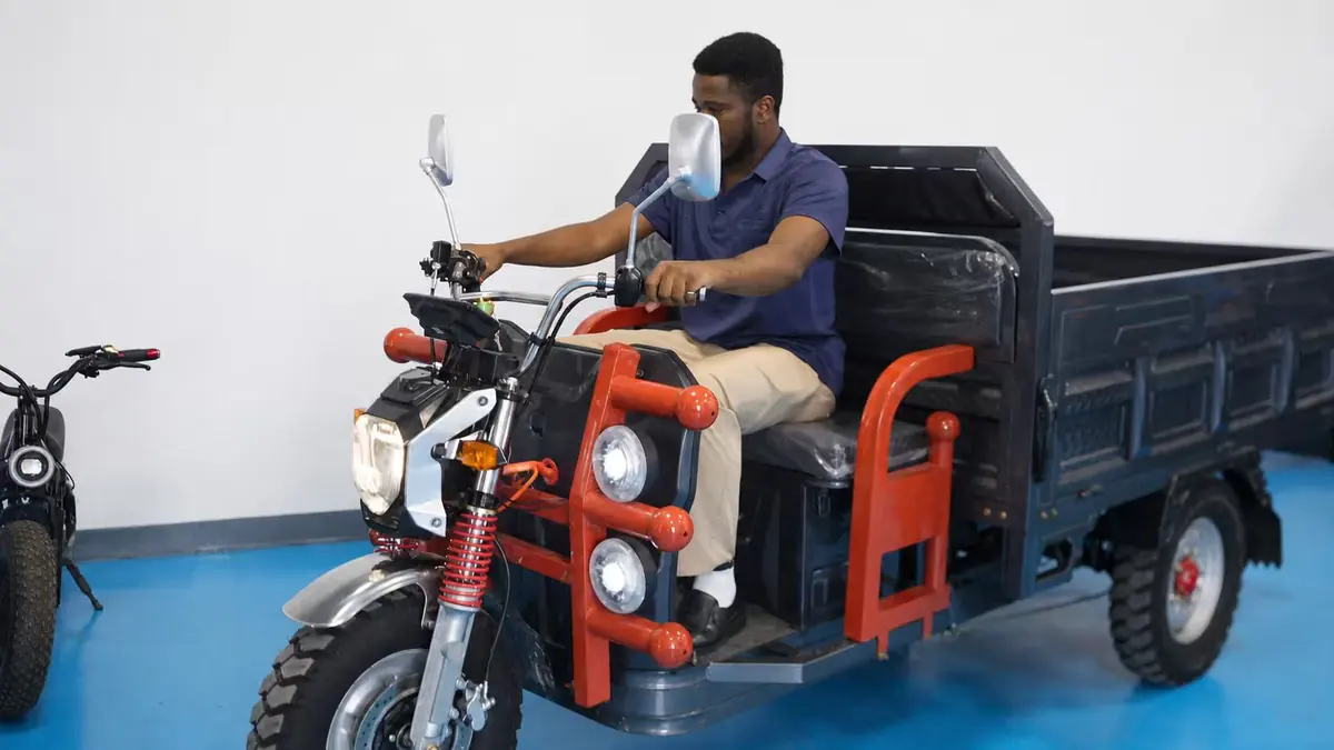 Customer testing a heavy-duty cargo electric tricycle in the showroom